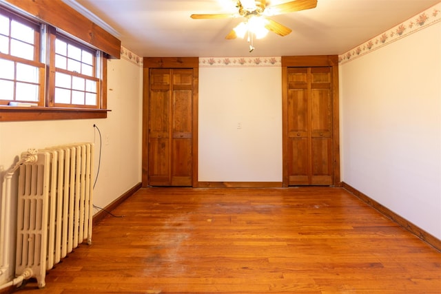 interior space with radiator and light hardwood / wood-style floors