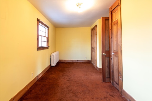 carpeted spare room with radiator