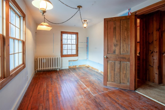 unfurnished room with dark wood-type flooring and radiator