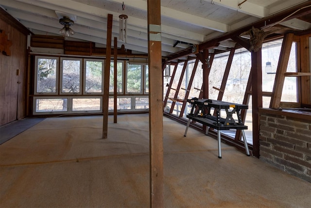 miscellaneous room with lofted ceiling, plenty of natural light, and light colored carpet