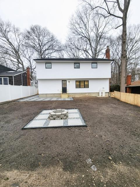 back of house with a patio and a fire pit