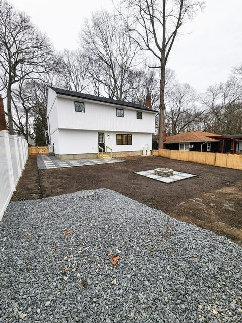 back of property featuring a patio area and an outdoor fire pit