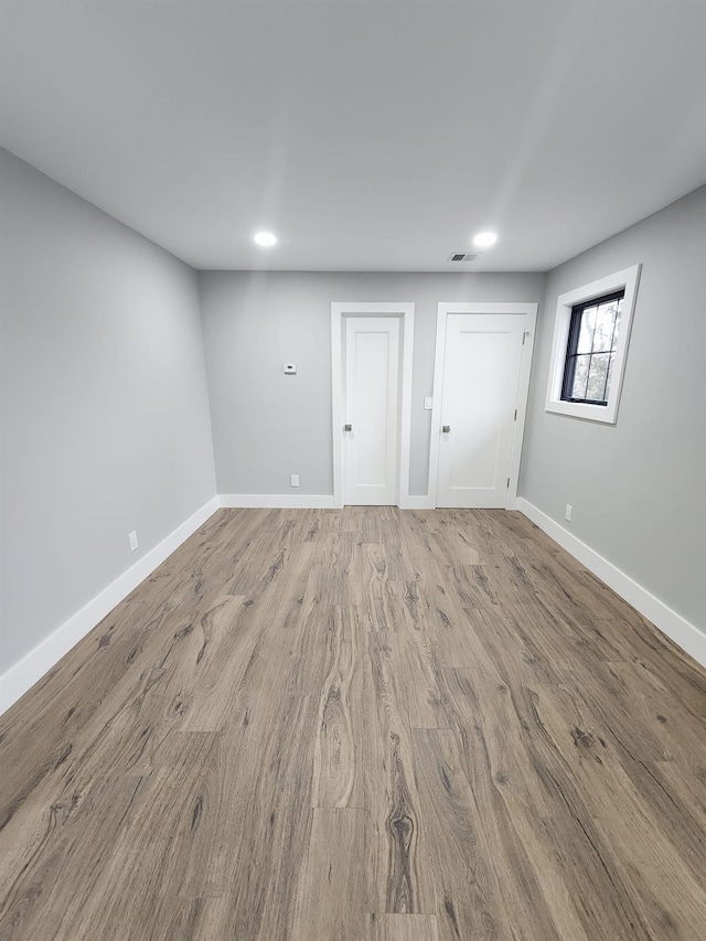 unfurnished room with light hardwood / wood-style flooring