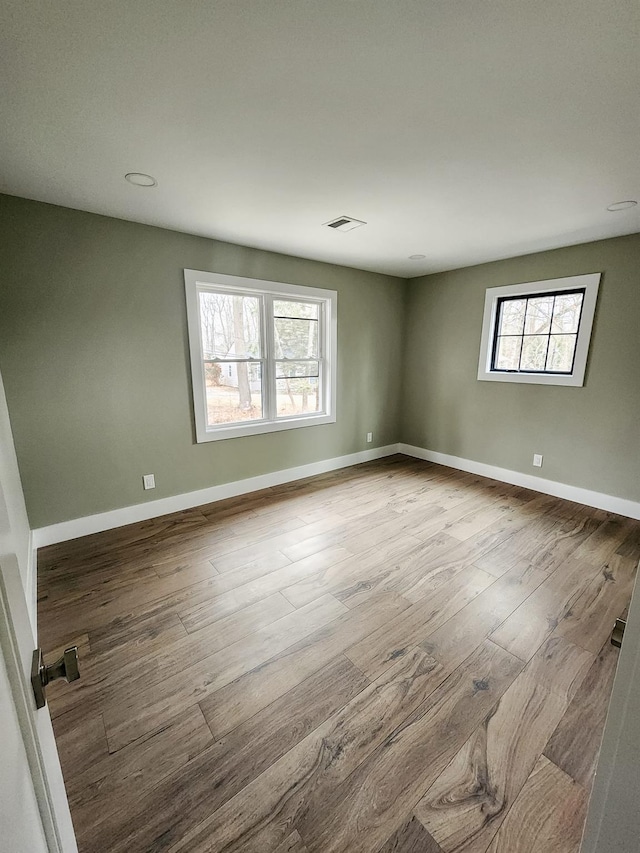 spare room featuring light hardwood / wood-style flooring