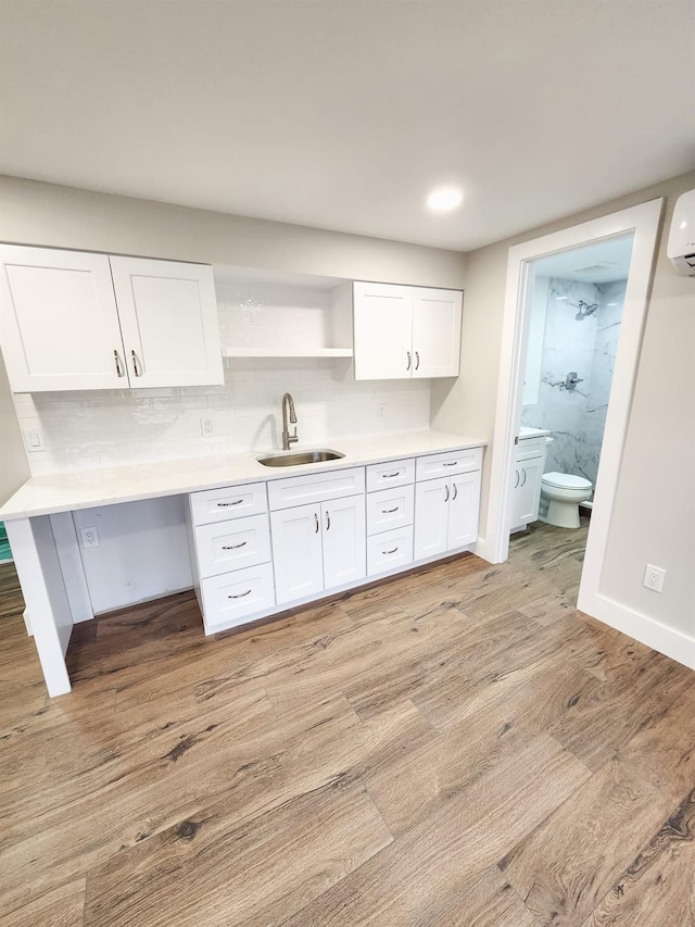 kitchen featuring white cabinetry, sink, and light hardwood / wood-style floors