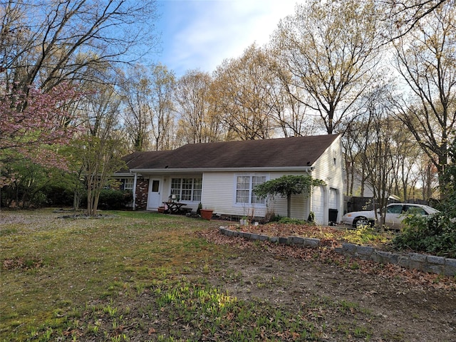 ranch-style home with a front lawn