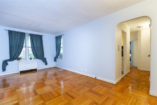 unfurnished room with light parquet flooring and radiator