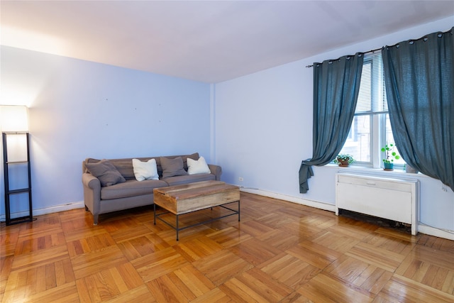 living room featuring radiator heating unit and light parquet flooring