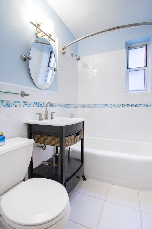 bathroom featuring tiled shower / bath combo, tile walls, tile patterned floors, and toilet