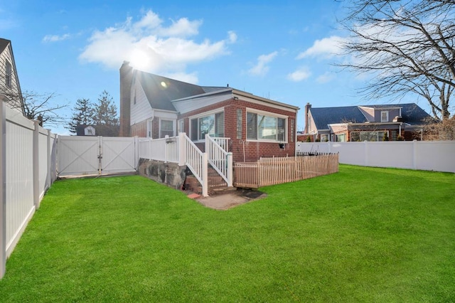 rear view of house featuring a lawn