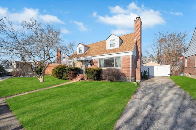 cape cod house with a front yard