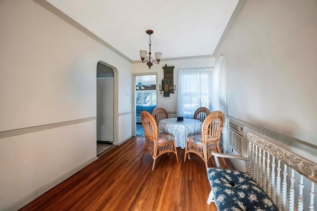 dining area with a wall mounted air conditioner, hardwood / wood-style flooring, ornamental molding, and a chandelier