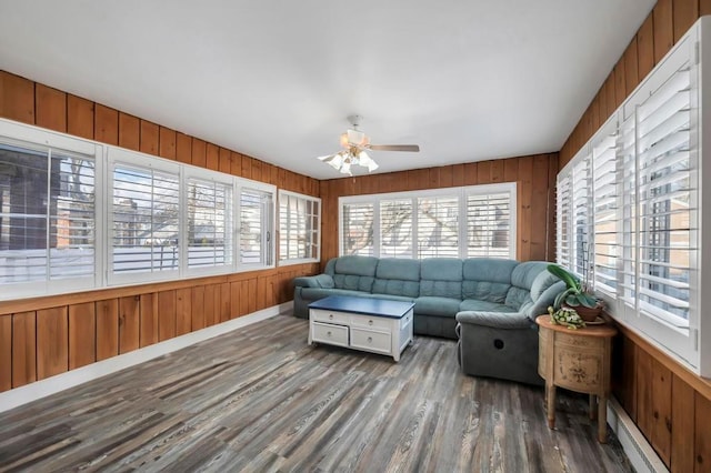 sunroom with ceiling fan and a baseboard radiator