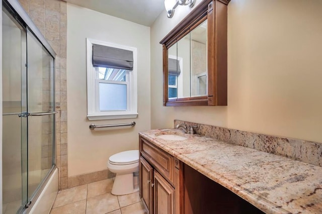 full bathroom featuring enclosed tub / shower combo, vanity, toilet, and tile patterned flooring