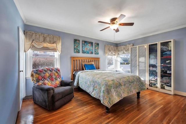 bedroom with wood-type flooring, ceiling fan, and crown molding