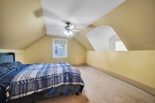 carpeted bedroom featuring lofted ceiling and ceiling fan