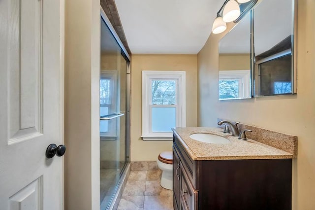 bathroom featuring an enclosed shower, vanity, tile patterned flooring, and toilet