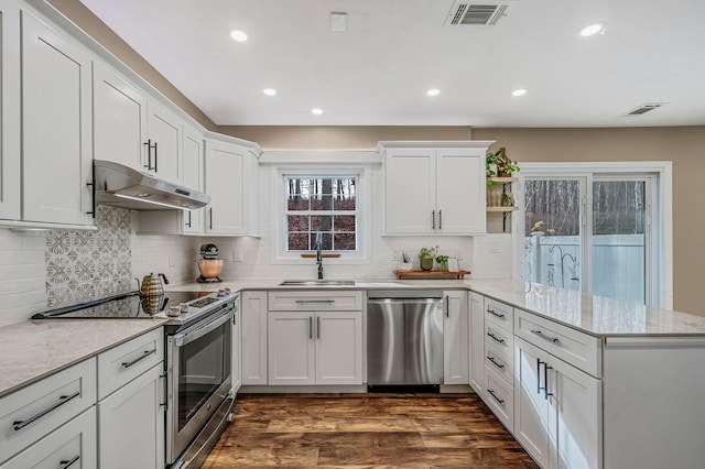 kitchen featuring white cabinetry, stainless steel appliances, kitchen peninsula, and sink