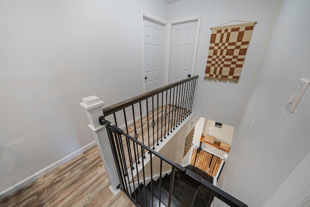 stairway with hardwood / wood-style floors