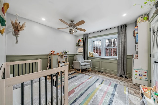 bedroom with ceiling fan and light hardwood / wood-style floors