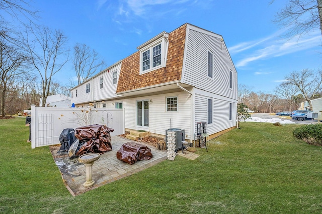 back of property featuring a yard, a patio, and central air condition unit