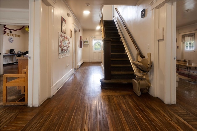 corridor featuring crown molding, dark hardwood / wood-style flooring, and a baseboard radiator