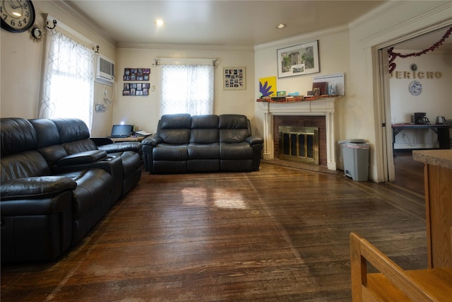 living room featuring a fireplace, ornamental molding, dark hardwood / wood-style flooring, and a wall unit AC