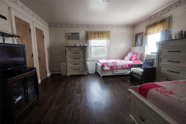 bedroom with a baseboard radiator, a wall mounted air conditioner, dark hardwood / wood-style floors, and multiple windows