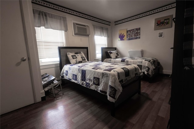 bedroom featuring dark wood-type flooring and a wall mounted AC