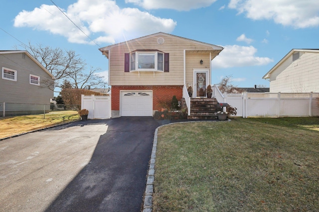 view of front of property with a garage and a front lawn