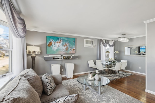 interior space featuring hardwood / wood-style flooring, ornamental molding, a chandelier, and a wall unit AC