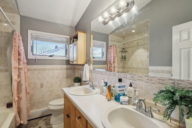 full bathroom with shower / tub combo with curtain, tile walls, tile patterned flooring, vanity, and toilet