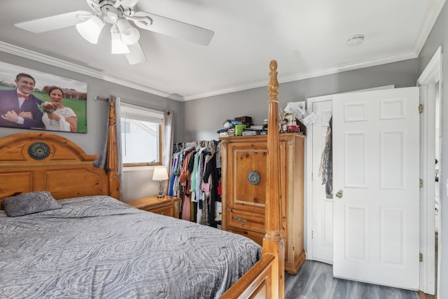 bedroom with ornamental molding, dark hardwood / wood-style floors, and ceiling fan