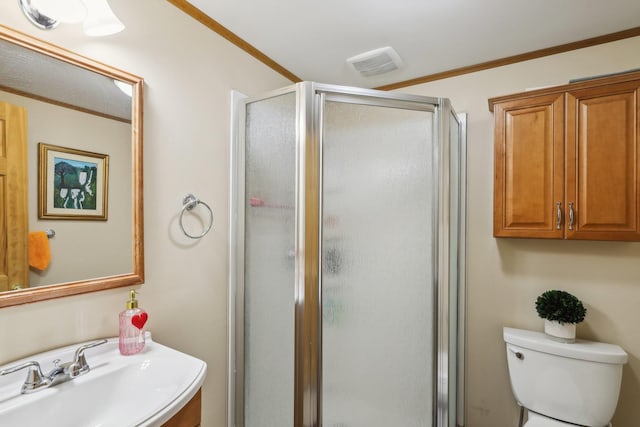 bathroom featuring walk in shower, toilet, sink, and crown molding