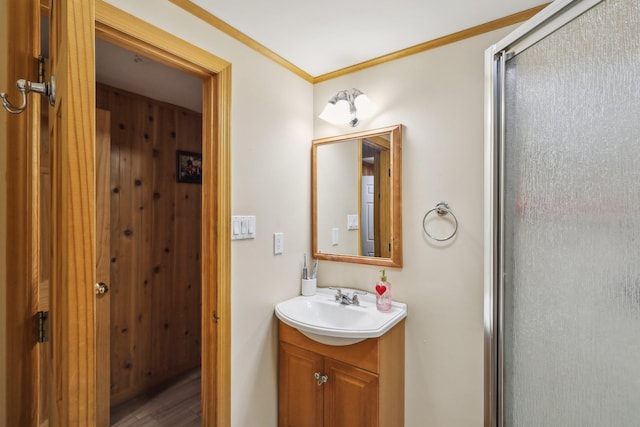 bathroom featuring vanity, an enclosed shower, and crown molding