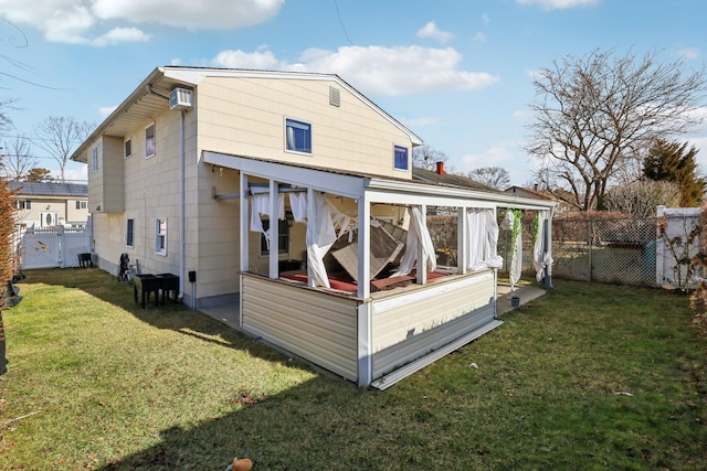 rear view of house with a lawn and an AC wall unit