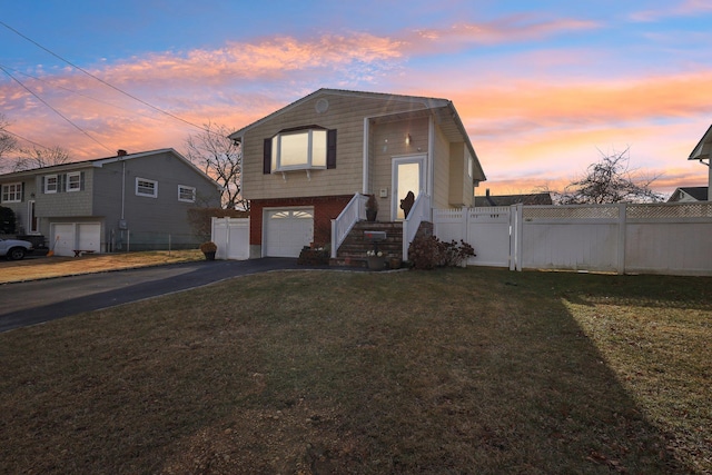 view of front of property featuring a garage and a yard