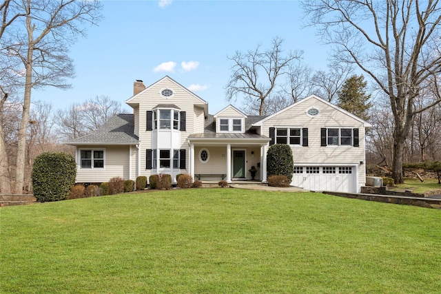 view of front of house featuring a garage, a chimney, a front lawn, and roof with shingles