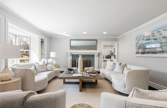 living area featuring ornamental molding, recessed lighting, a stone fireplace, and baseboards