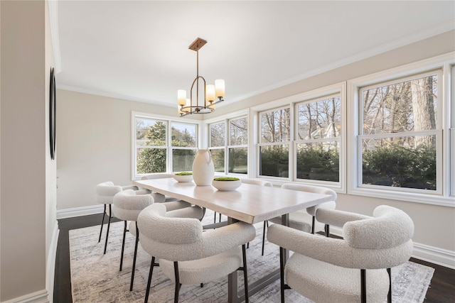 dining space with ornamental molding, dark wood-style flooring, a chandelier, and baseboards