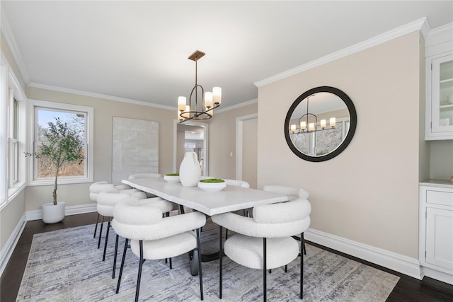 dining space featuring baseboards, a chandelier, dark wood finished floors, and ornamental molding