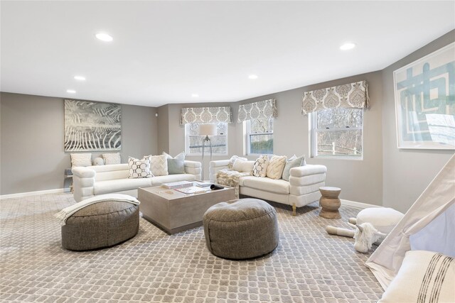 carpeted living area with recessed lighting and baseboards