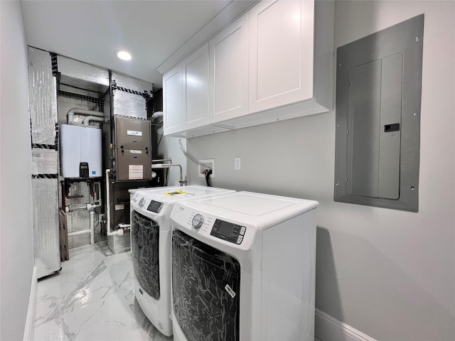 clothes washing area featuring electric panel, cabinets, and washing machine and clothes dryer