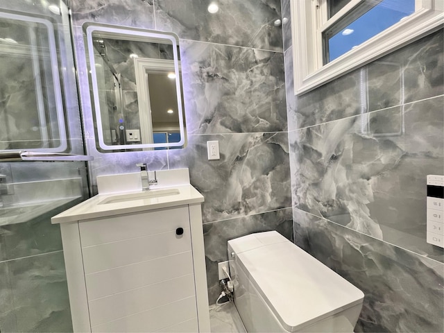 bathroom with vanity and tile walls