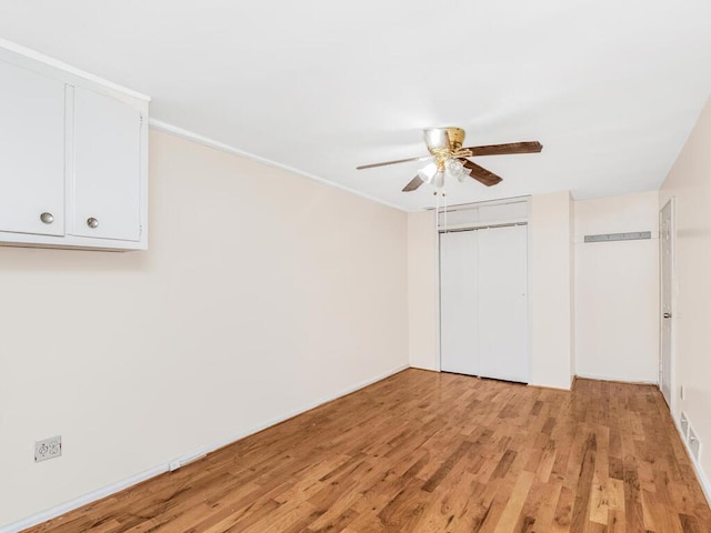 unfurnished bedroom featuring ceiling fan and light wood-type flooring