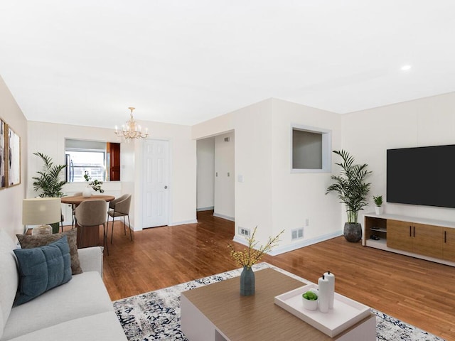 living room featuring a notable chandelier and wood-type flooring