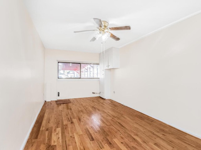 empty room featuring ceiling fan and light wood-type flooring