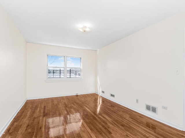 spare room featuring wood-type flooring