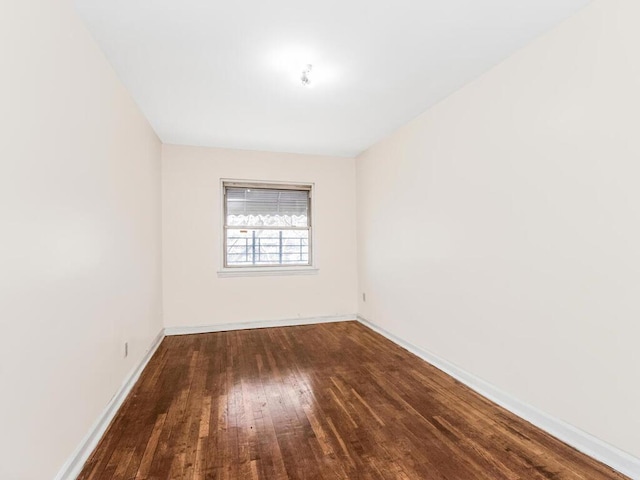 unfurnished room featuring dark hardwood / wood-style flooring