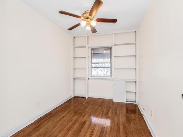 empty room featuring dark hardwood / wood-style floors and ceiling fan